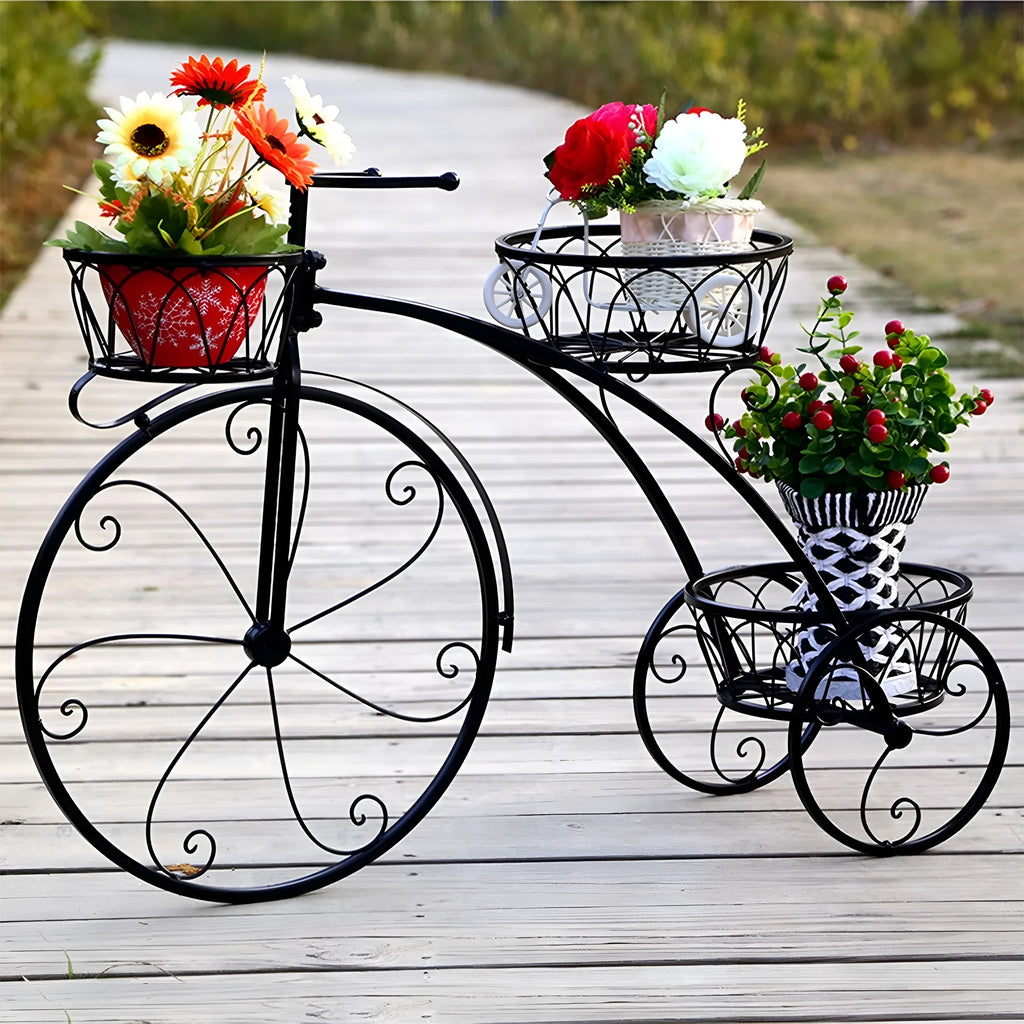 Black iron tricycle plant stand with three round basket holders for smaller planters in home, garden, or patio