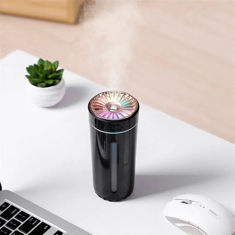 Black portable car humidifier with colourful lights on a car dashboard cup holder