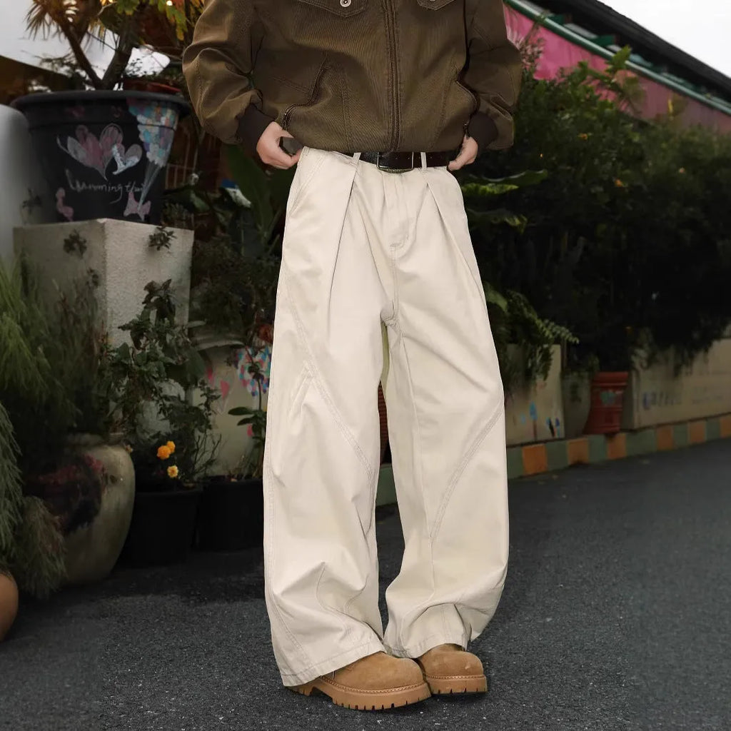 Men's pleated straight-leg trousers in a striped pattern, showing loose fit and straight hem.