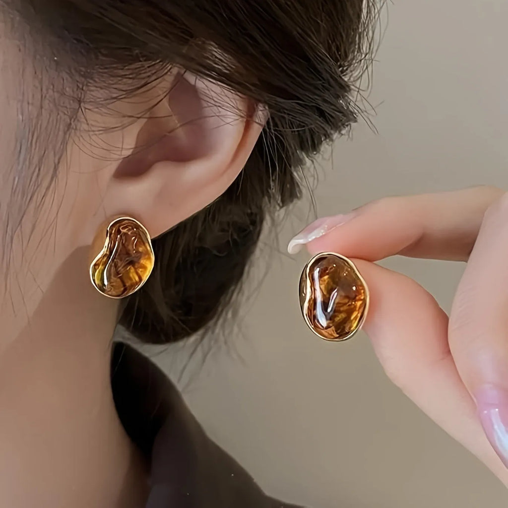 Set of three geometric alloy earrings with tassel detailing in gold, amber and tiger eye colours