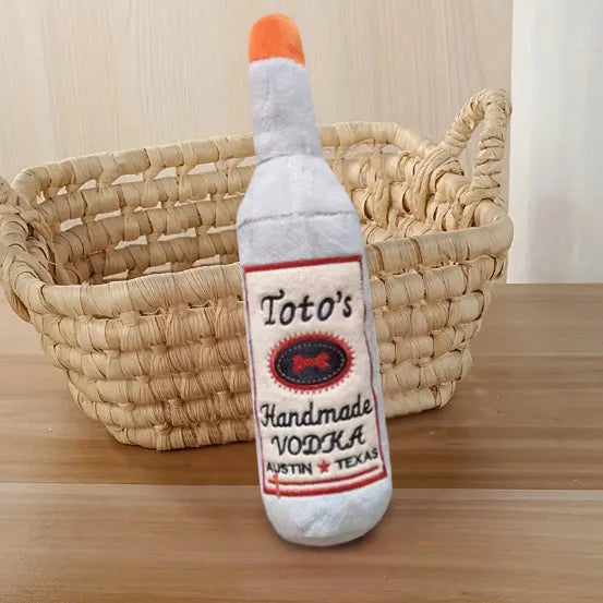Brown plush dog toy shaped like a wine bottle with textured surfaces and a squeaker.
