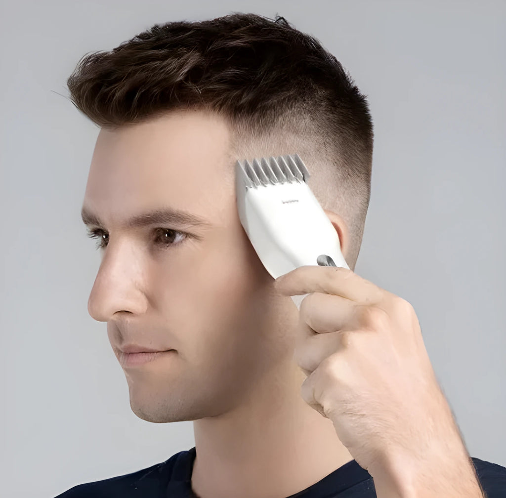 Black cordless electric hair clippers with ceramic blade and adjustable comb on a white background