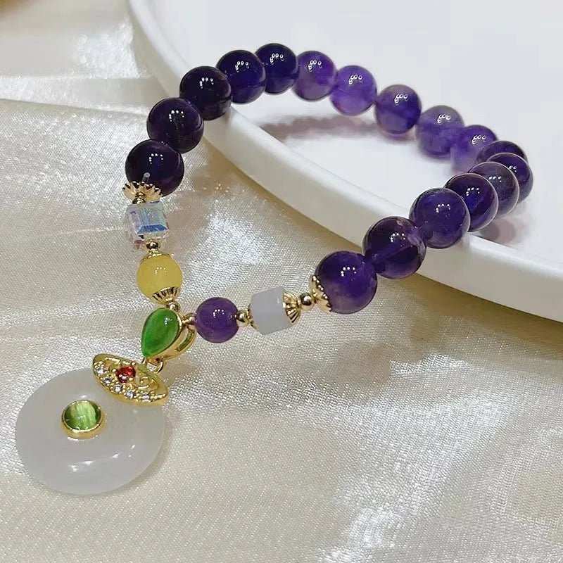 Purple amethyst bracelet with money bag pendant and peace buckle on wrist