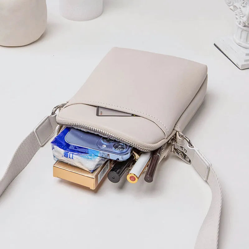Solid colour small crossbody shoulder bag for mobile phones in beige.