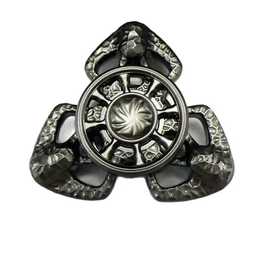 Flame Butterfly metal alloy rotating gyro spinner fidget toy on a flat surface.