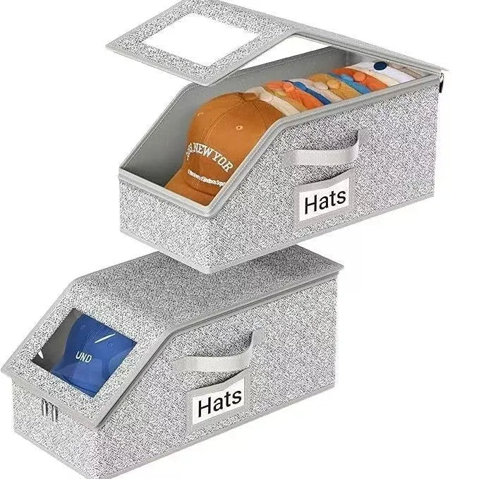 Grey foldable fabric storage box with cover, shown next to a baseball cap.