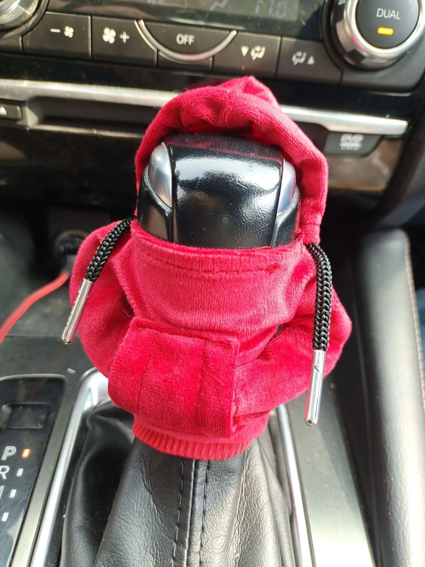 Knitted pure cotton gear lever decoration cover in assorted colours on a car gearstick.