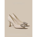 Women's pointed-toe stiletto heels in creamy white or black with a low-cut design and rubber sole.