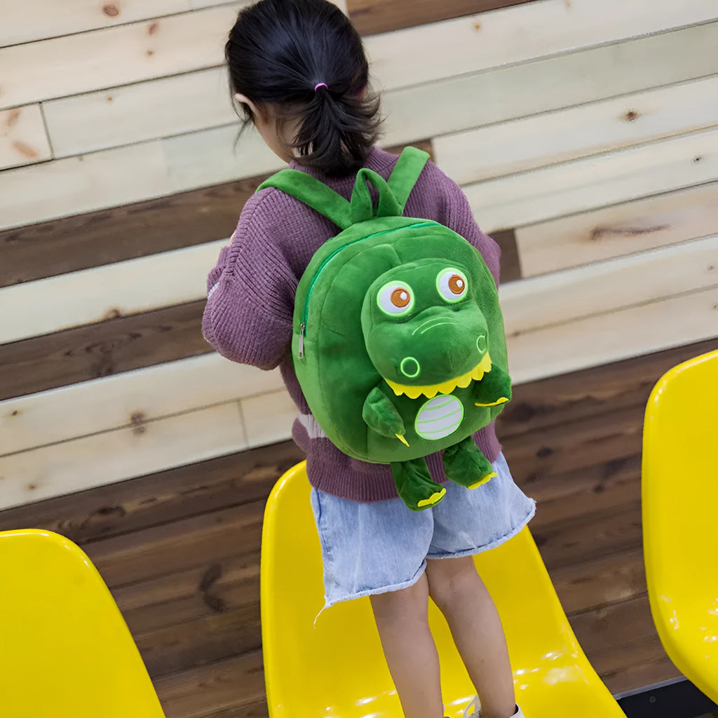 Soft blue dinosaur plush backpack for children with embroidery, shown with a soft handle and polyester lining.