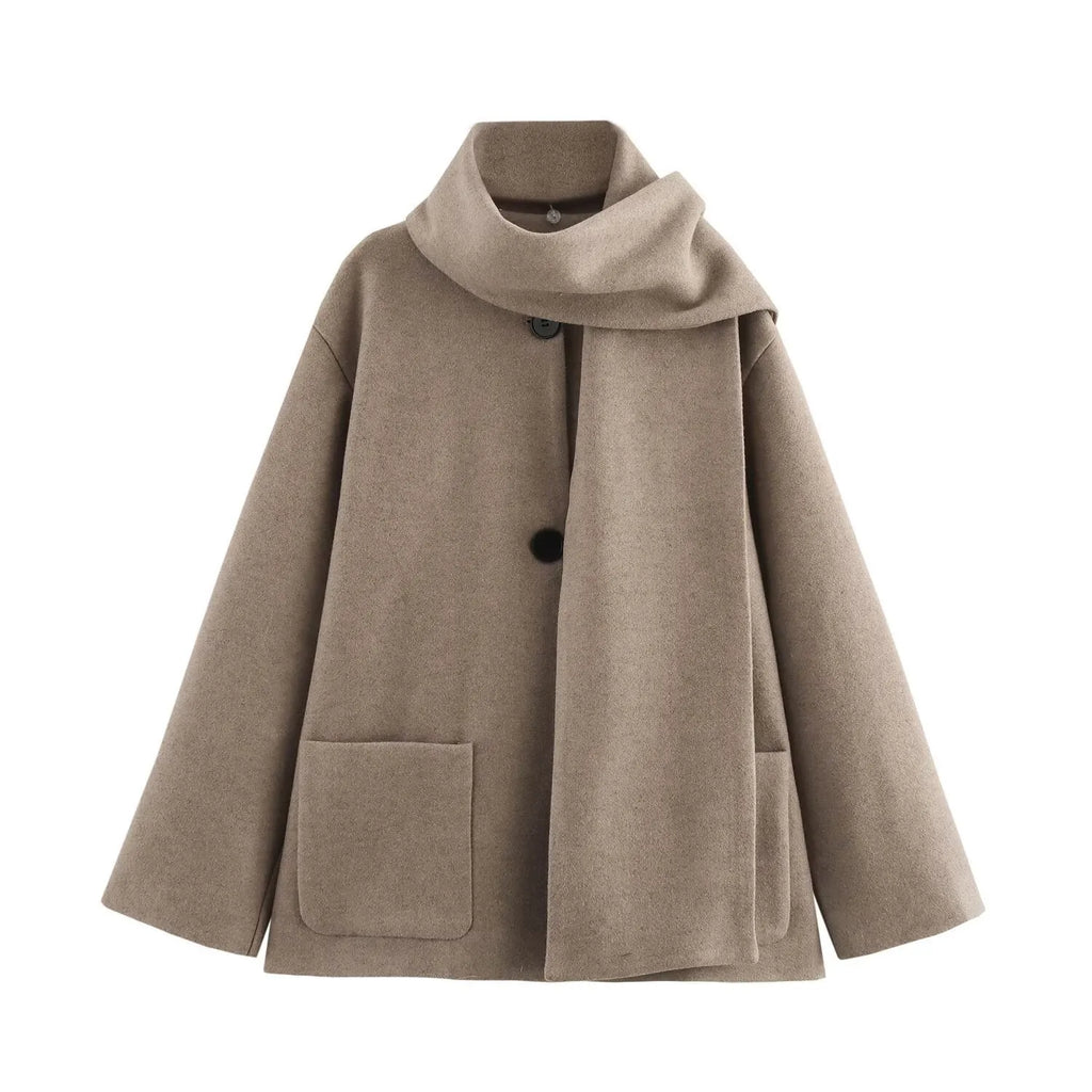 A woman wearing a longline black polyester coat with a detachable faux fur collar.
