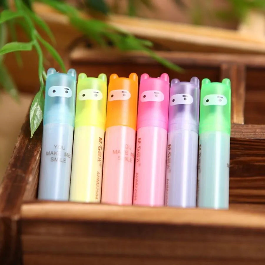 Set of six plastic barrel highlighter pens with chisel tips in six different colours, showing oblique pen shape.