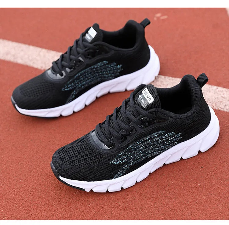 Women's low-top platform sneakers in black and white with cross-strap detail and MD sole.