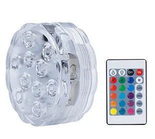 IP68 waterproof LED remote control diving light with 16 colour modes placed in a glass vase of water
