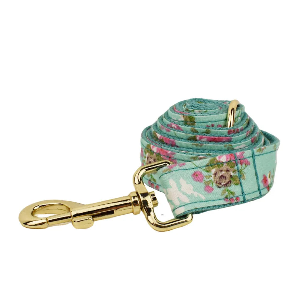 Rose patterned dog collar and leash set with green background, detachable bow, and matching cloth vest.