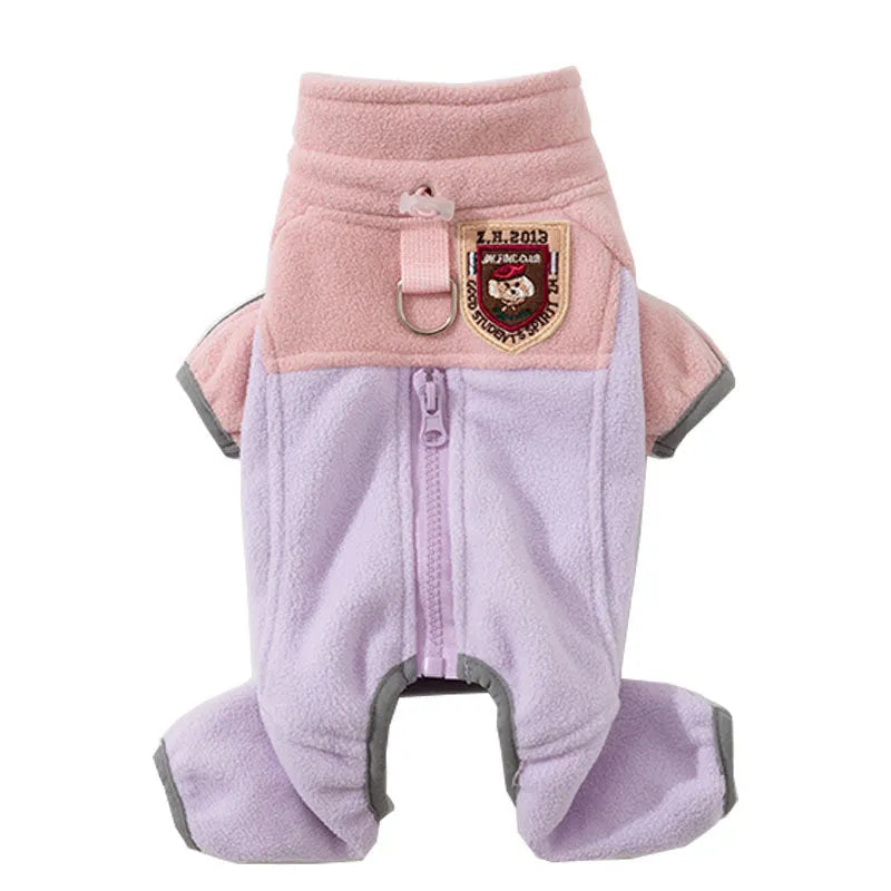 Small dog wearing a colour-block fleece jumpsuit in purple and pink, with full-zip front and leash ring
