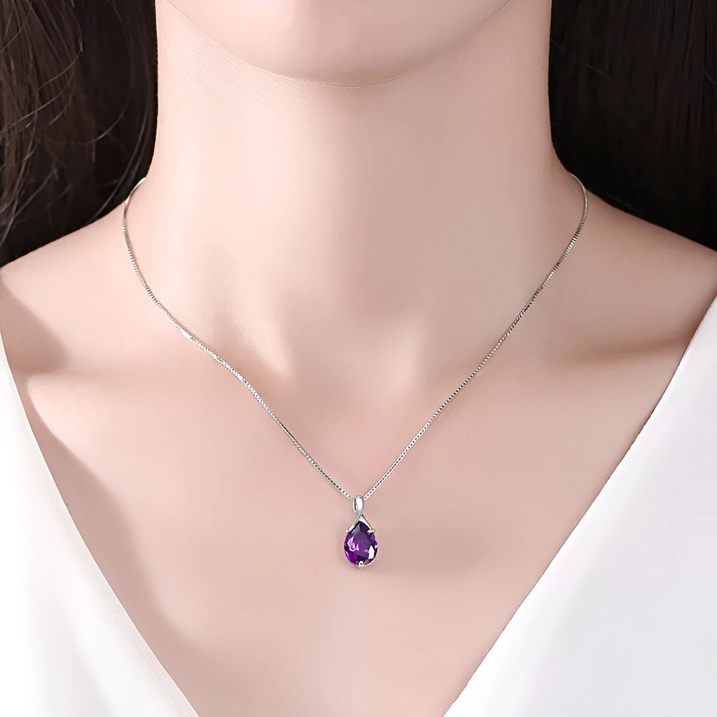 Sterling silver S925 pendant with amethyst stone and diamond-like accents on white background