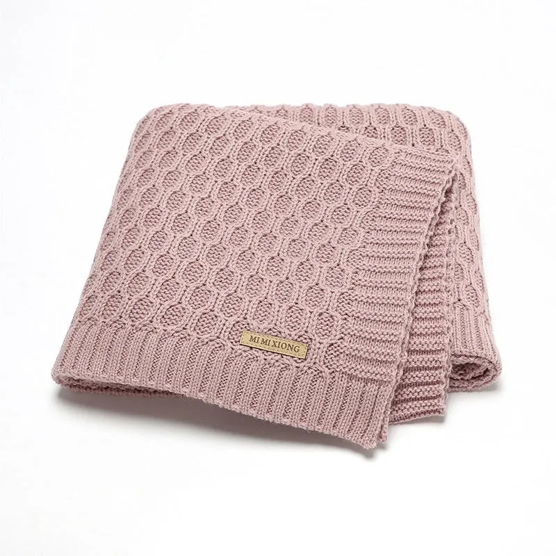 Solid colour baby hug blanket with raised line texture, shown in a light green colour.