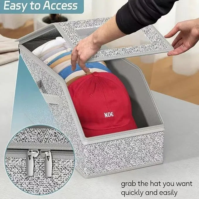 Grey foldable fabric storage box with cover, shown next to a baseball cap.
