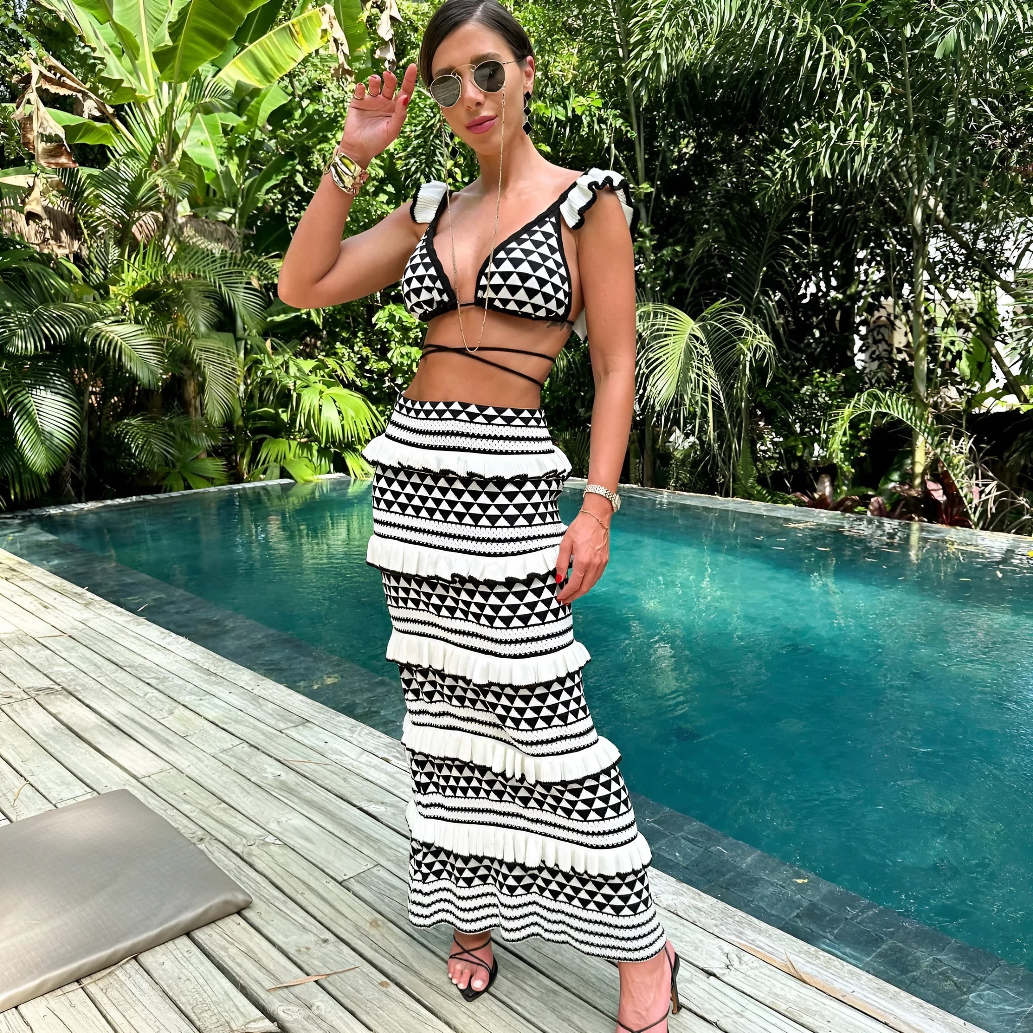 Black and white striped women's bikini top with ruffled straps and matching long knitted skirt.
