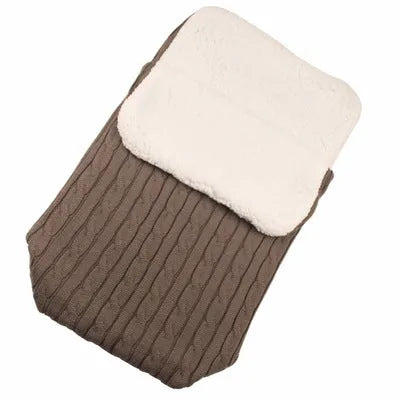 Envelope-style baby stroller sleeping bag in a plain colour, shown on a pram with lamb cashmere lining visible.