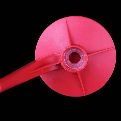 Red plastic Magic Tap soda drink dispenser attached to an inverted 2-litre bottle