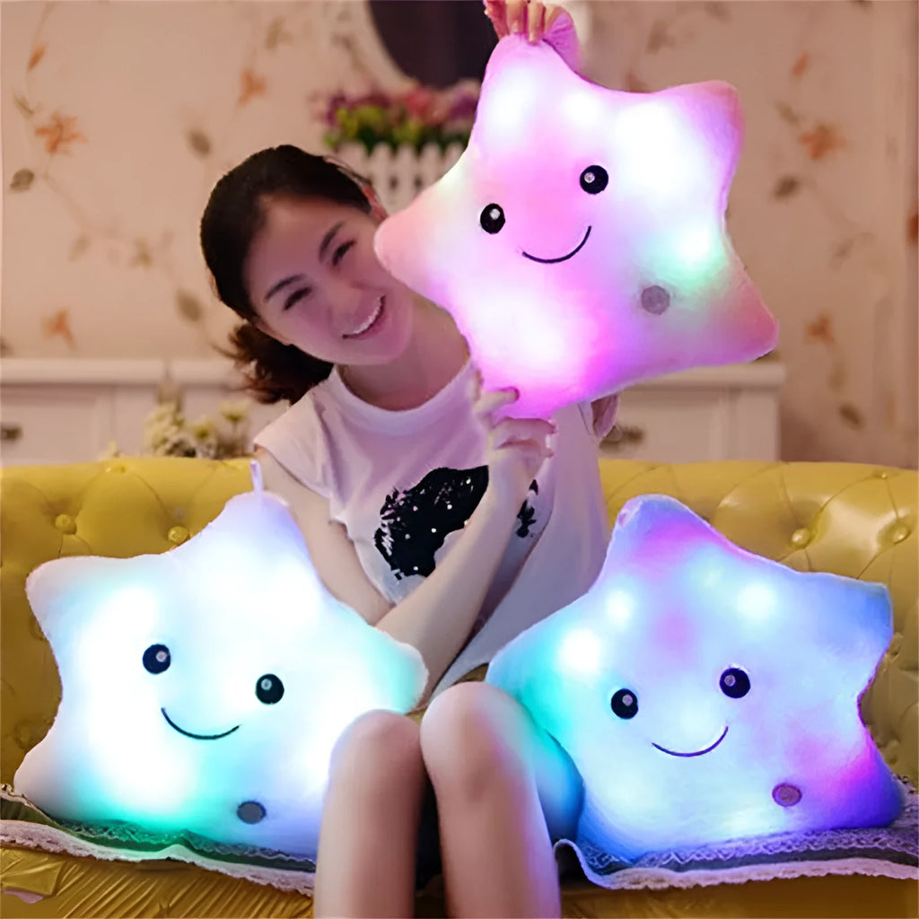 Colourful glowing five-pointed star plush pillow on a dark background, showcasing its soft texture and luminous light.