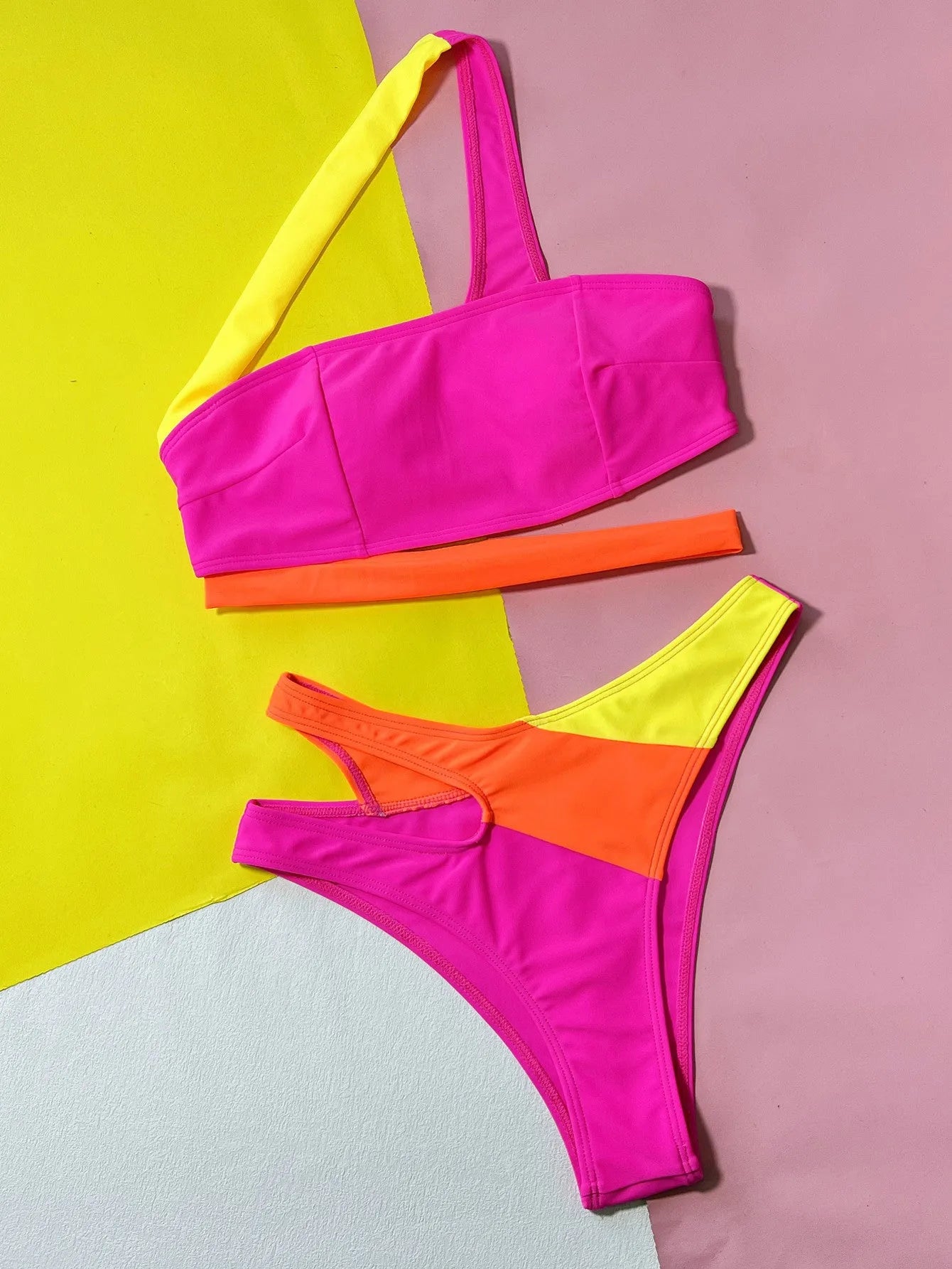 Rose red women's bikini with hollow contrast colour split design on a two-piece swimsuit set.