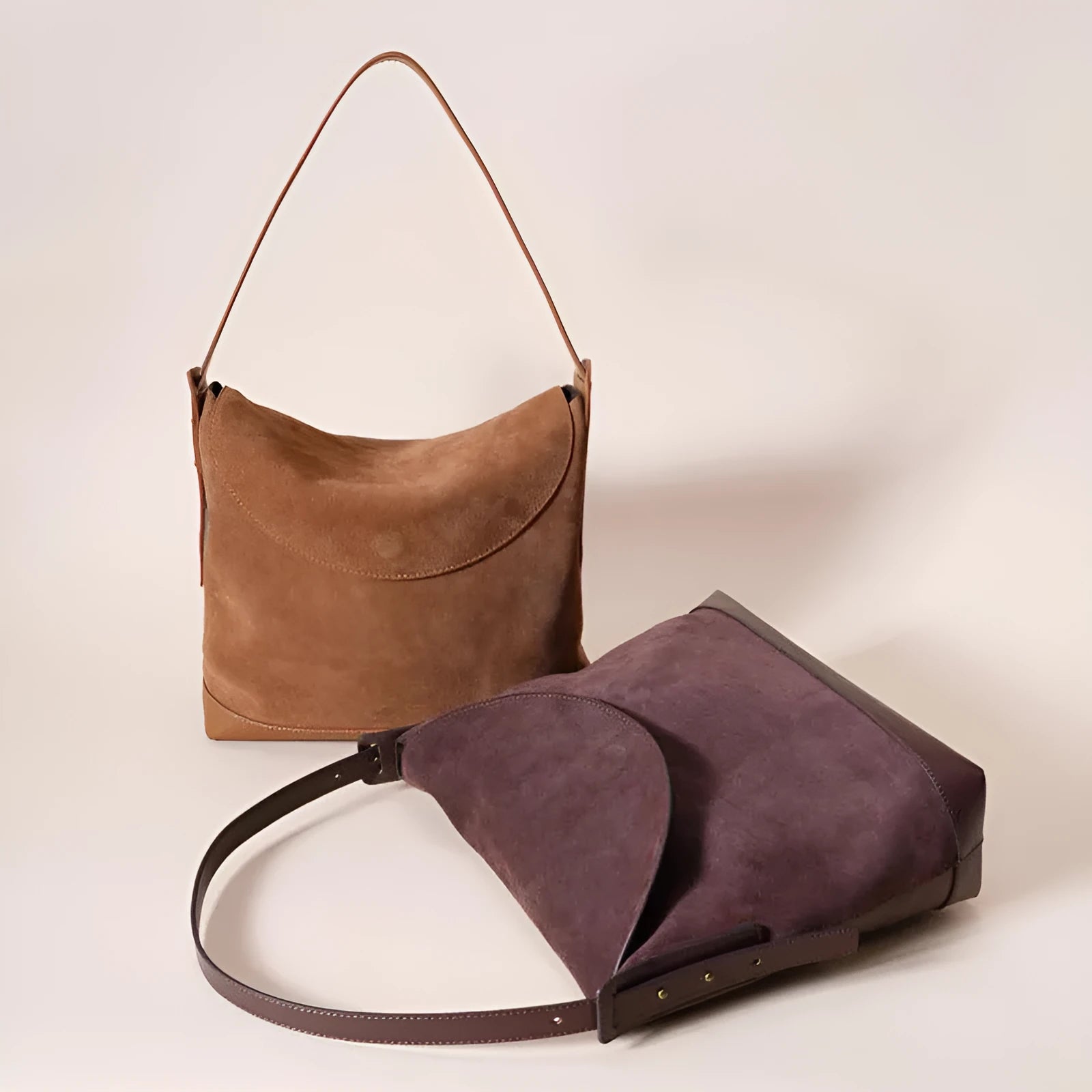 Light brown genuine leather women's retro shoulder bag with clamshell opening on a table.