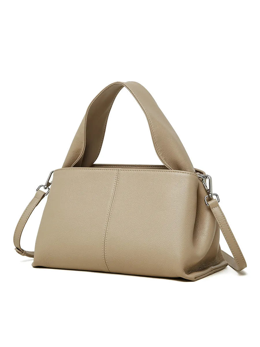Women's brown retro texture leather messenger bag with a double shoulder strap shown on a table.