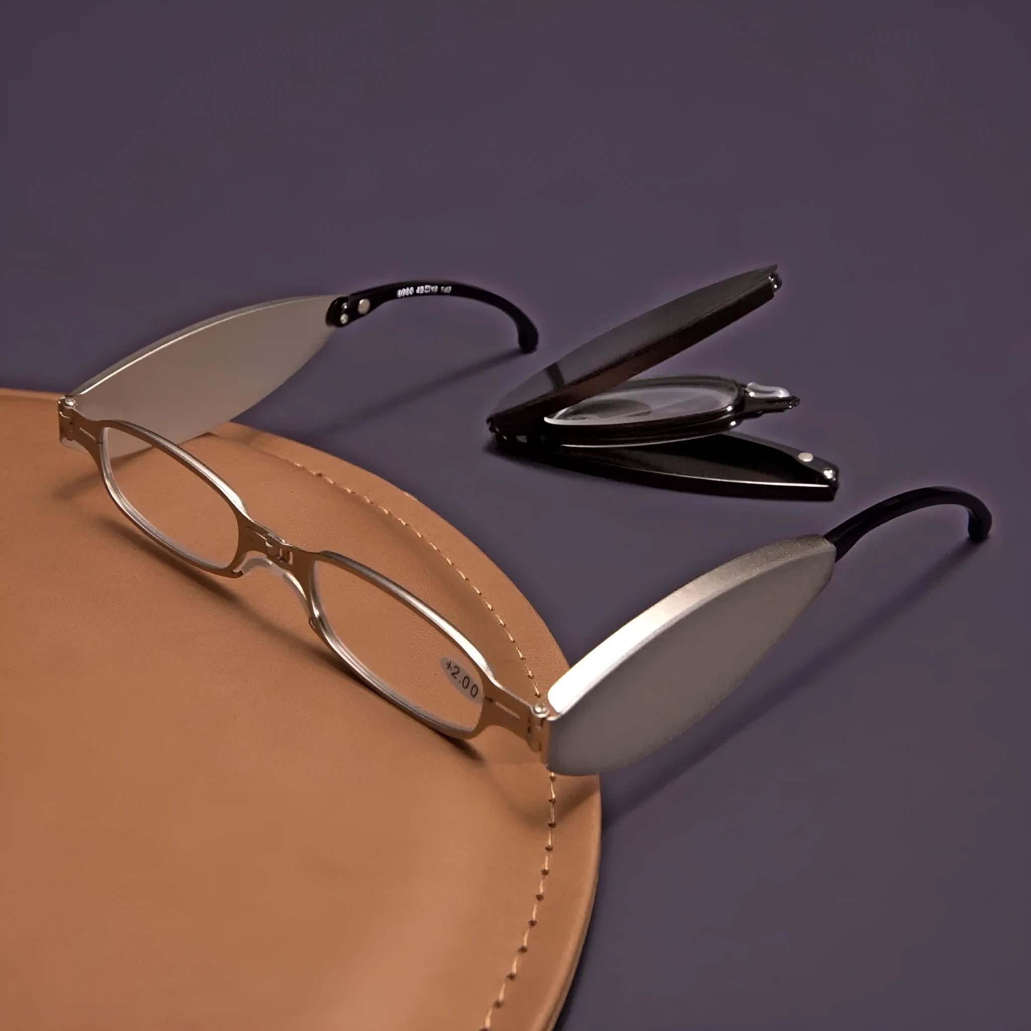 Black folding presbyopic glasses with metal frame and ring detailing shown open and folded