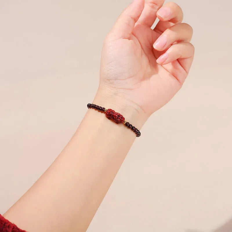 A square geometric bracelet for women made from natural Garnet and Strawberry Quartz with a carved Pixiu charm.