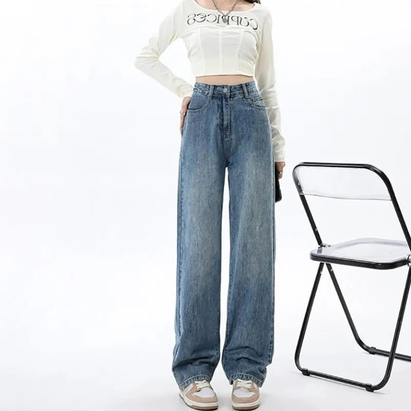 Woman wearing high-waisted retro blue wide leg jeans with a straight-leg cut.
