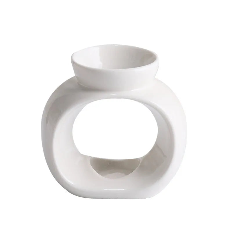 White Nordic style ceramic aromatherapy stove ornament on a wooden surface