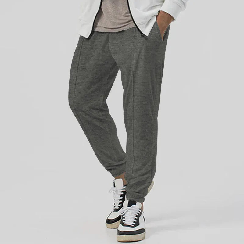 Men's grey casual tapered sweatpants with an elasticated waistband and straight-leg design