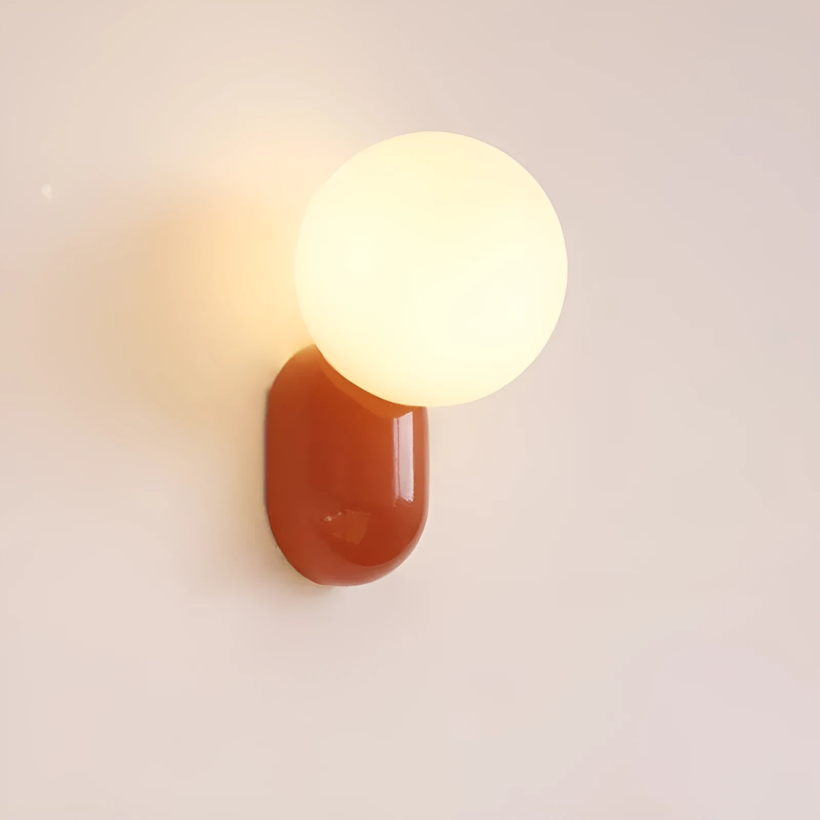 Small night lamp with alloy body and glass shade in matte black, 12×21cm, on a wall