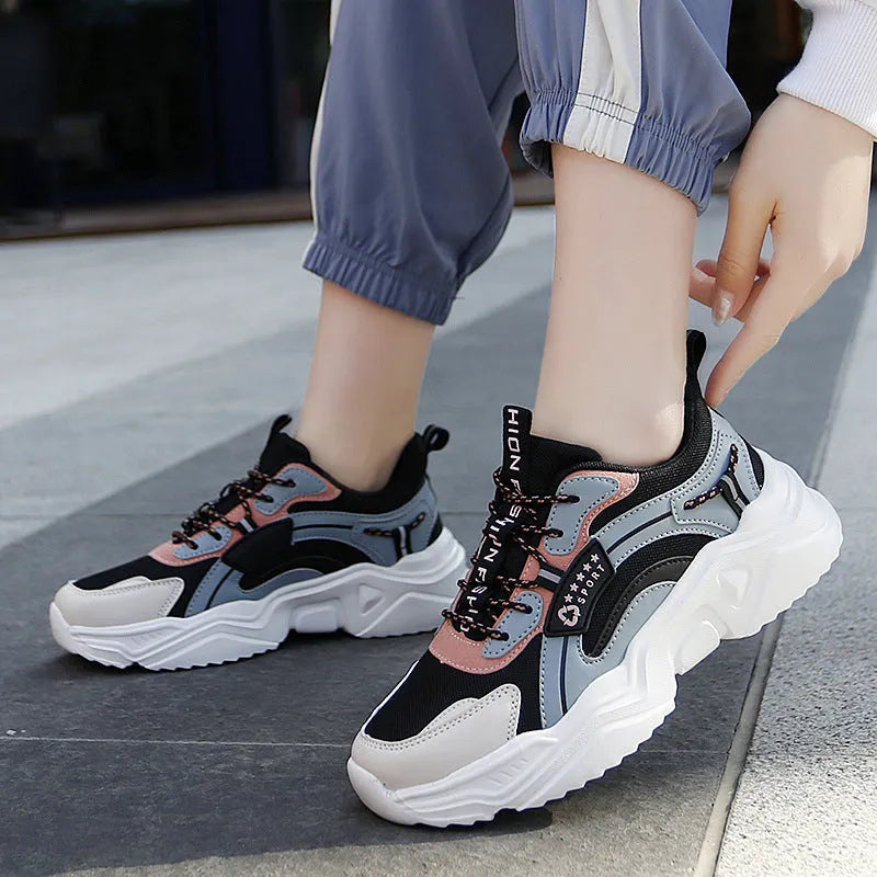 White women's casual sports shoes with mesh upper, thick PU sole, round toe, and a buckle strap.