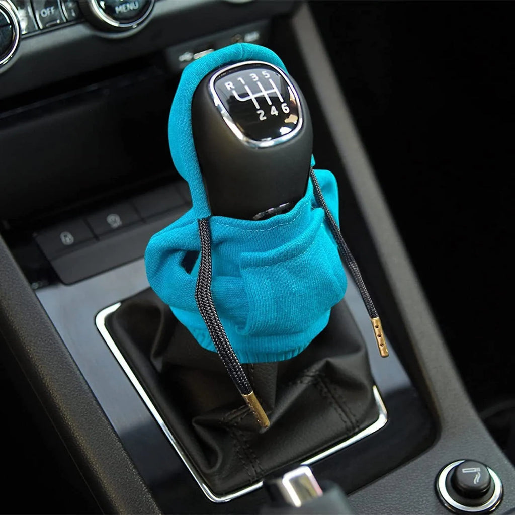 Cloth car gear shift knob hoodie cover in multiple colour options next to a gear lever.