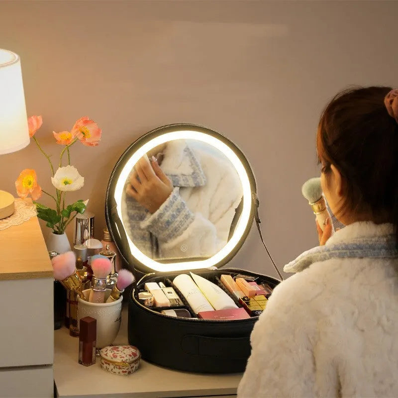 Round pink PU leather makeup bag with LED mirror open, showing internal partitions and carry strap.