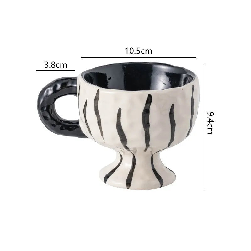 Hand-pinched irregular ceramic mug in a solid colour, showing its unique shape.