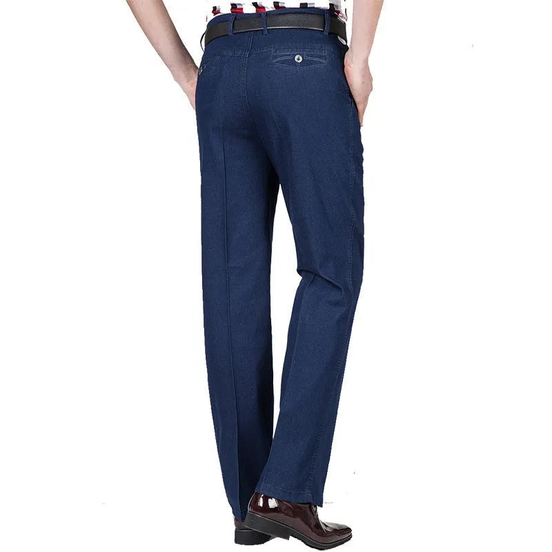 Men's high-waist loose fit blue denim jeans with zipper fly on size chart background