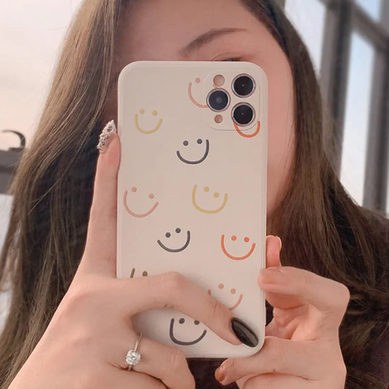 Silicone TPU phone case with painted smiley design for iPhone, shown in rainbow colour.