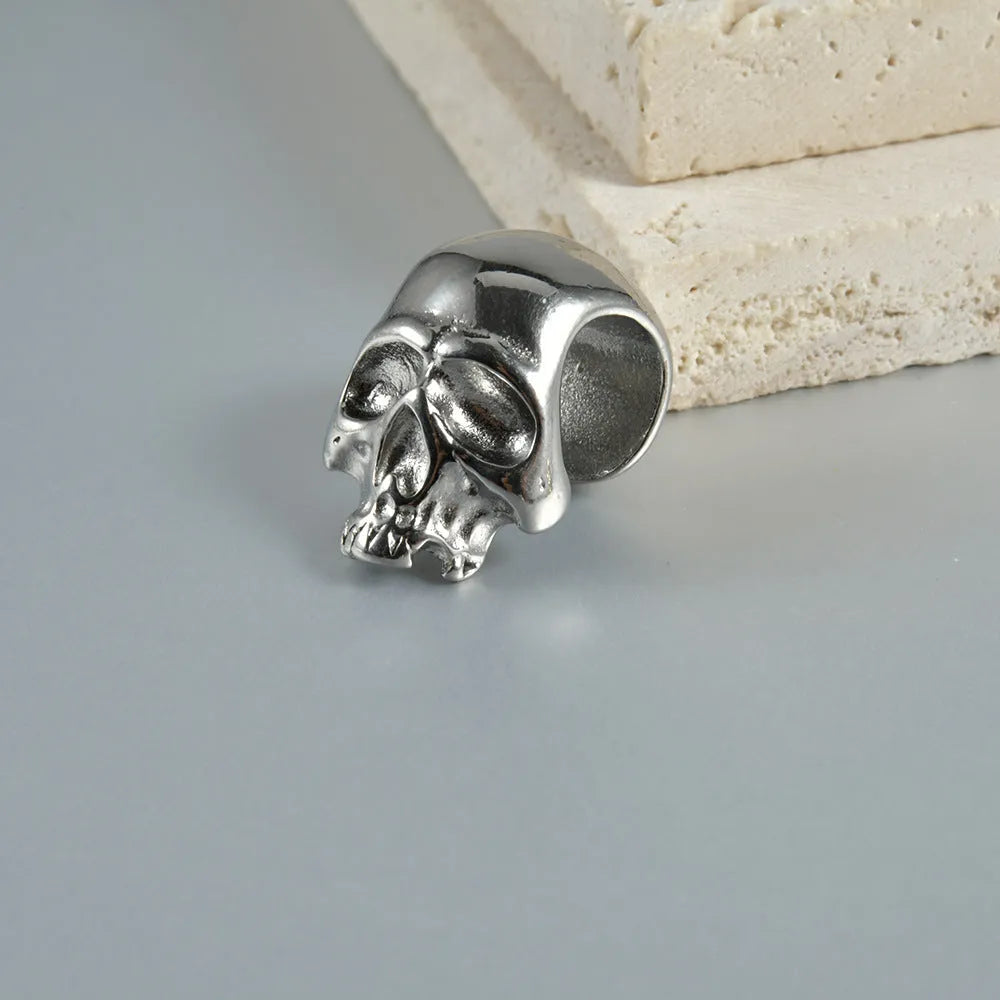 Stainless steel hollow skull and Buddha head earrings in hip hop style.