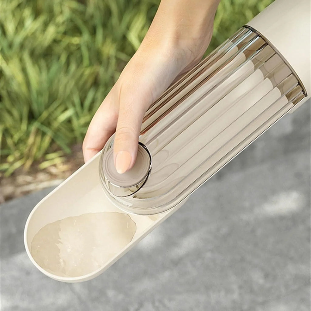 Beige foldable dog water bottle with food dispenser base for outdoor walking and travel