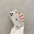 Transparent soft TPU iPhone case with a built-in clear love heart charm and chain.