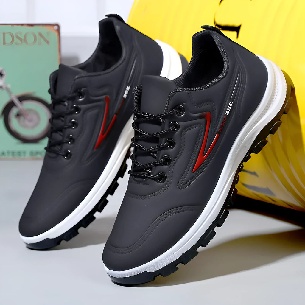 Black and grey low-top waterproof casual shoes with a lace-up front and plastic sole.