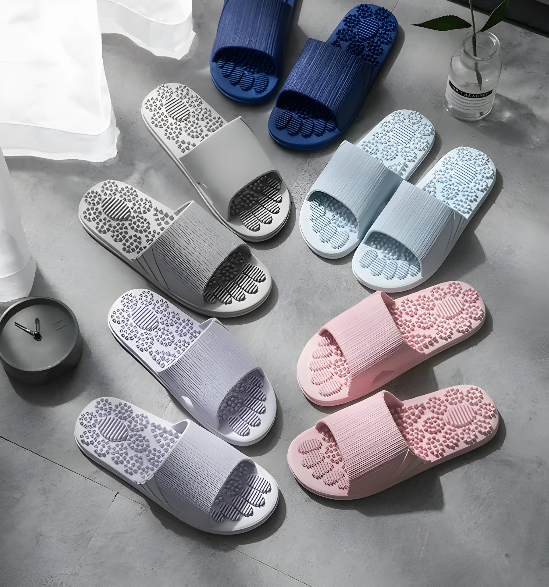Pair of reflexology foot massage slippers with 3D acupressure particles, blue colour, on a light background