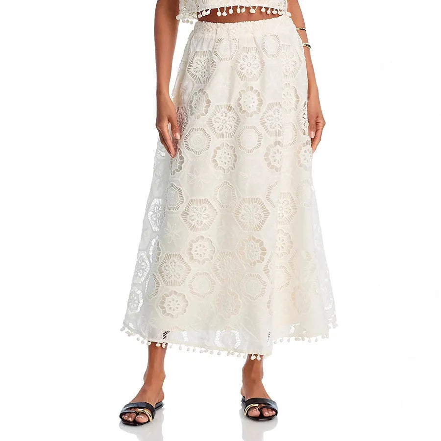 White women's retro style two-piece suit with sleeveless top, long skirt, and embroidery detail.