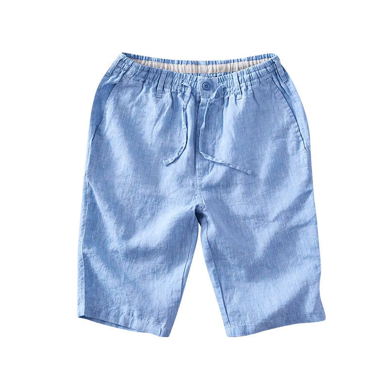 Men's loose-fitting linen capri pants in a light colour, showing the straight-leg style.