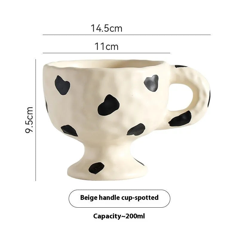 Hand-pinched irregular ceramic mug in a solid colour, showing its unique shape.