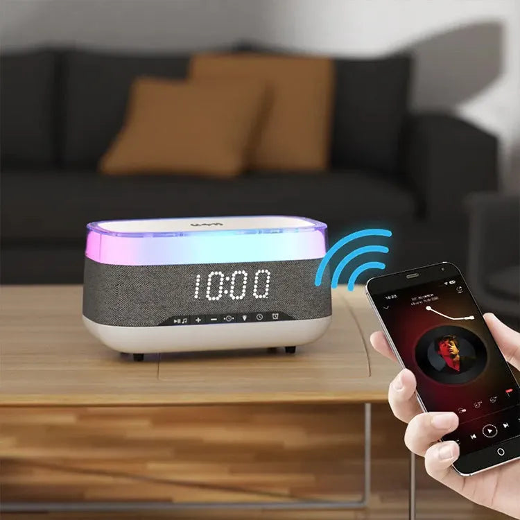 White multifunctional alarm clock with Bluetooth speaker and wireless charging pad on a table